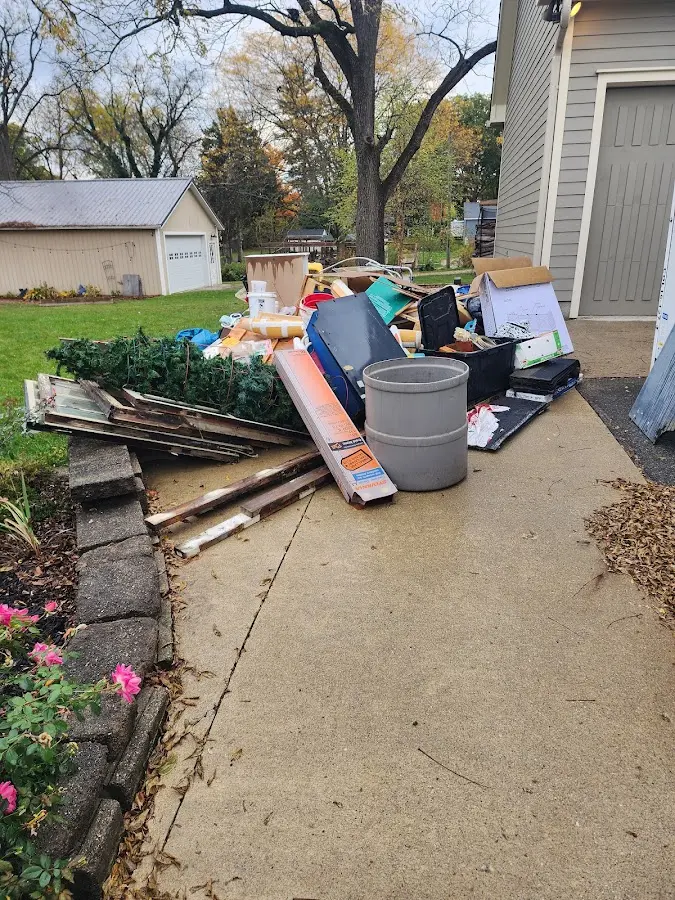 Dumpster being loaded with debris for Estate Cleanout Dumpster Rental in Woodland Park